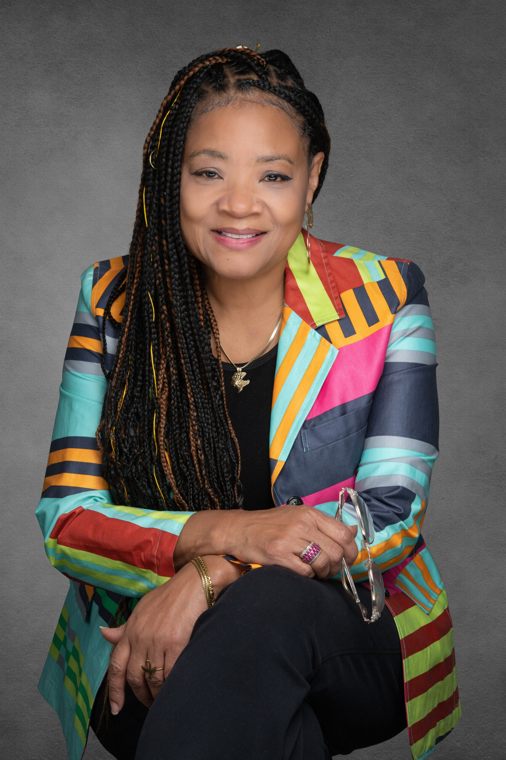 A portrait of a black woman wearing a colorful outfit